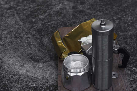 Moka pot and coffee grinder on natural dark background. Coffee making concept.の写真素材
