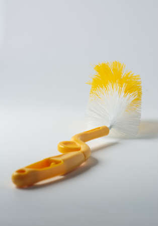 Yellow bottle brush on white background. Health care concept.の写真素材