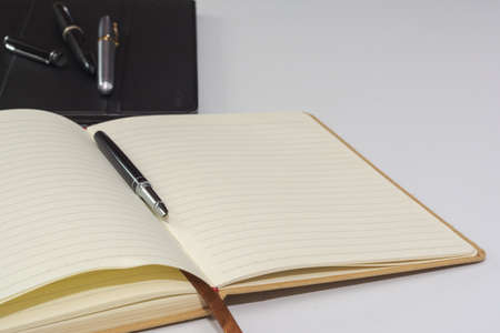 Notebook and fountain pen isolated on white background.