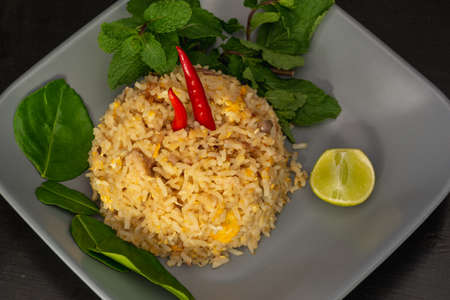 Mackerel fried rice isolated on dark background.の写真素材
