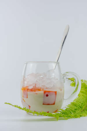 Cold papaya smootie isolated on white background. Fresh drink.の写真素材