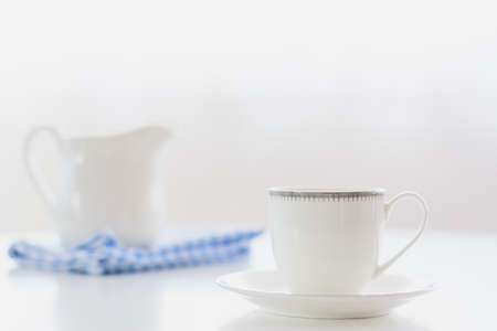 white porcelain tea set on natural light background.
