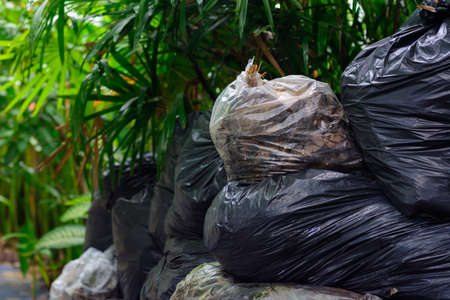 A pile of trash packed with biodegradable plastic bags on natural light background.の写真素材