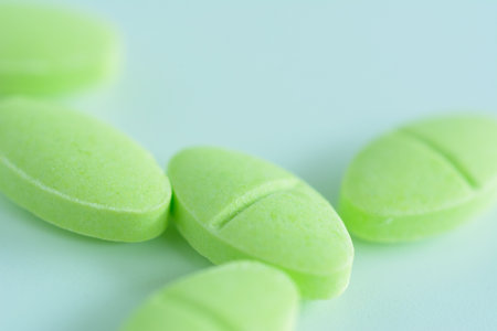 Cough pill on light green background. Health care concept.の写真素材