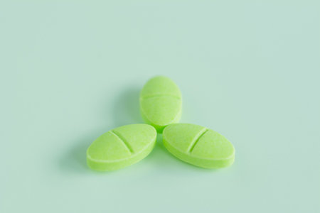 Cough pill on light green background. Health care concept.の写真素材
