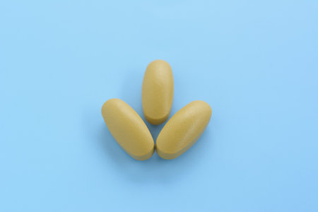 Multivitamins and minerals tablets on natural light blue background.の写真素材