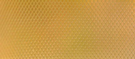 Rhombus pattern steel grating on natural gold light background.の写真素材