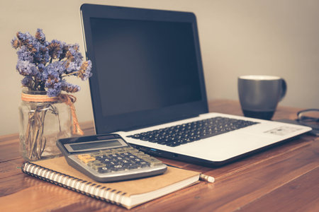 Office supplies on a wooden working table, Office workspace. Vintage retro picture style.