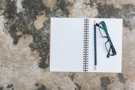 View from above of office  supplies on a cement wall background.の写真素材