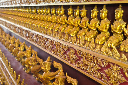 Many small Buddha statue on the wall at  temple, Thailand の写真素材