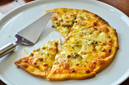 A pizza with a slice removed