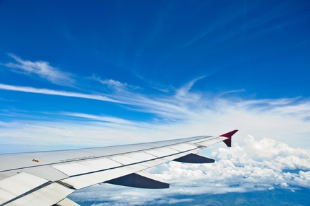 Wing of the plane with the blue skyの写真素材