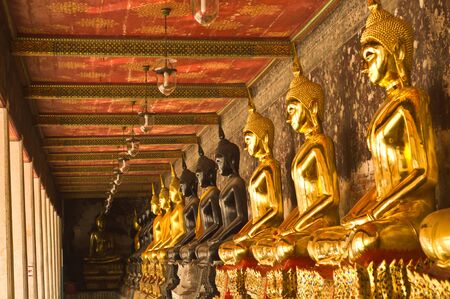 A row of golden  buddha and black buddha ,Bangkok Thailand