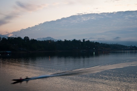 Silhouette fast boat in the lake  , Thailand の写真素材