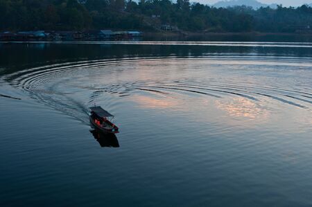 Silhouette boat in the lake の写真素材
