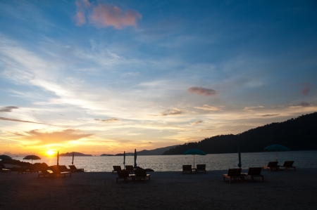 Sunset on the beach with sunbedの写真素材