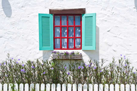 Colorful window on white wall of vintage house styleの写真素材