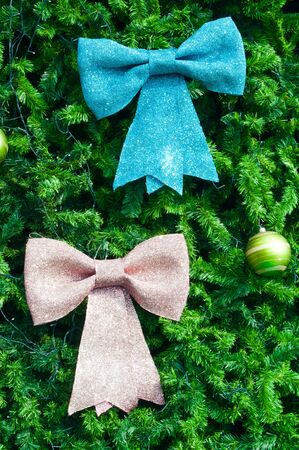 Blue and pink bow on christmas treeの写真素材