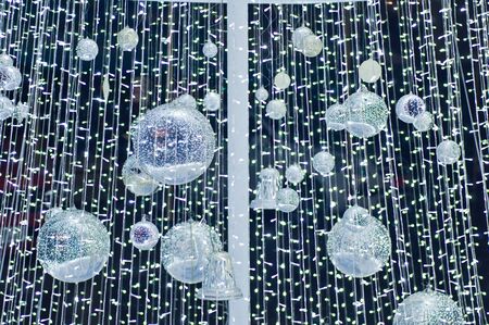 Small lamp with lighting on white christmas tree symbolの写真素材