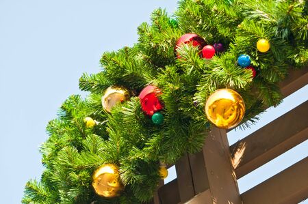 Colorful balls and lamp on christmas tree branchの写真素材