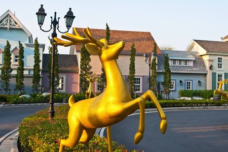 Golden rain-deer statue on the streetの写真素材