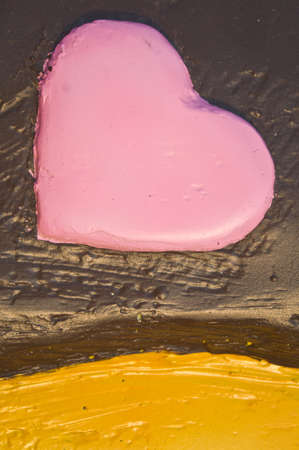 Pink heart-shaped with yellow and chocolate backgroundの写真素材