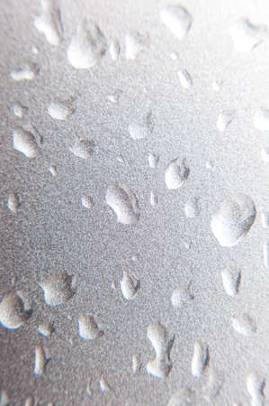 Bubbles of water on silver wall