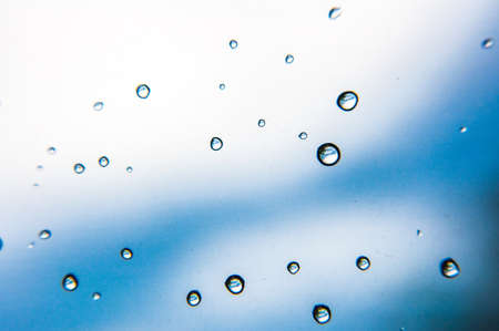 Water drops on blue glass wall