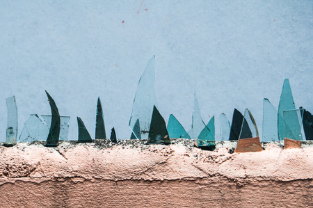 Broken glass on the cement wallsの写真素材
