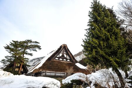 Scenery of small wood chalet over snow covered on sloped roof in Japanのeditorial素材