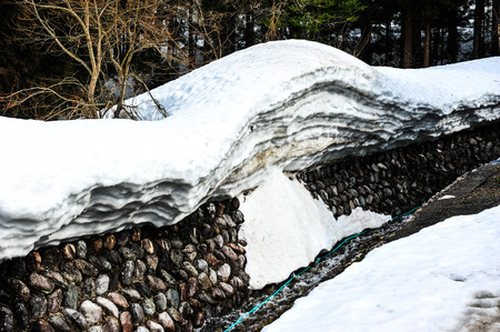 White snow and rock wallの写真素材