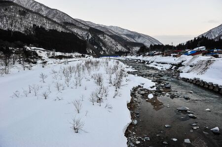 Winter panoramic view in the evening of snow creek and mountain