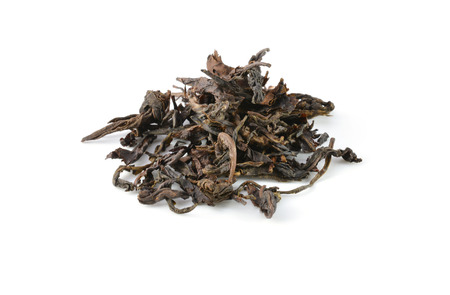 dry black tea leaves isolated on whiteの写真素材