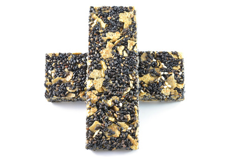 Honey bars with black sesame seeds isolated on white の写真素材