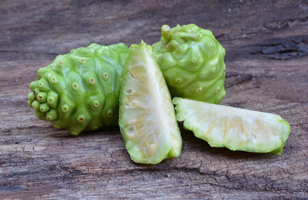 noni fruit on woodの写真素材