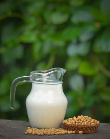 Milk with soy beans on wooden background.の写真素材