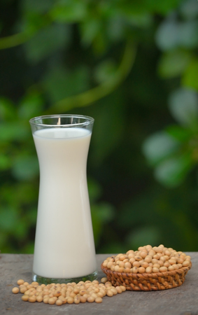 Milk with soy beans on wooden background.の写真素材