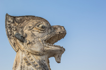 Old lion in front of thai templeの写真素材