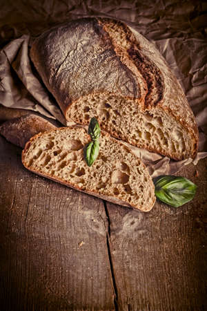 Freshly baked traditional bread on wooden table の写真素材