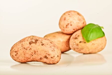 Little yellow patatos sliced on pure white backgroundの写真素材