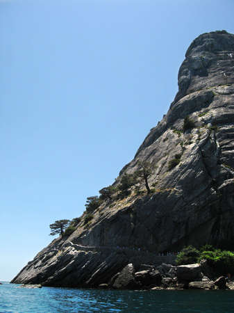 Heigh mountain and sea on the blue sky backgroundの写真素材