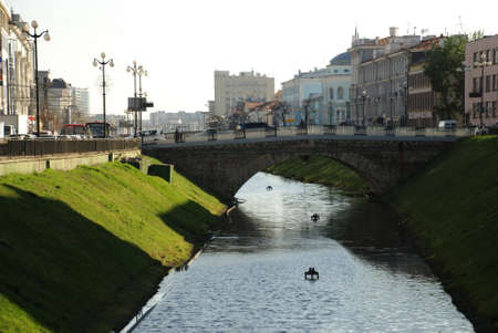 Water channel in the city and green grassの写真素材