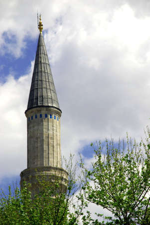 High minaret on the sky background and spring foliageの写真素材
