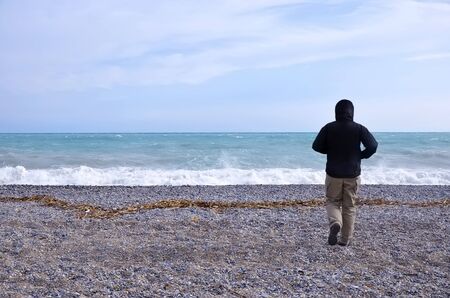 Man looks at the seaの写真素材