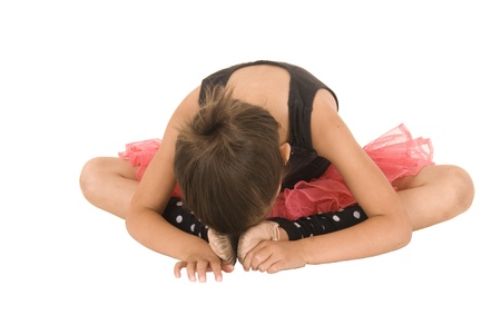 young ballerina girl bent over head downの写真素材