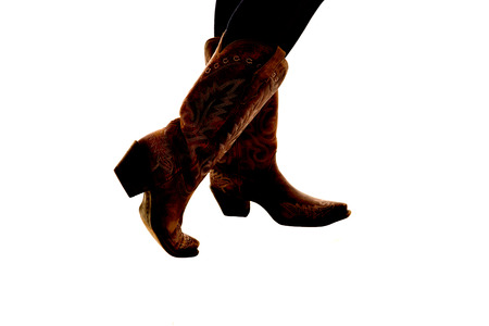 semi silhouette of cowboy boots white backgroundの写真素材