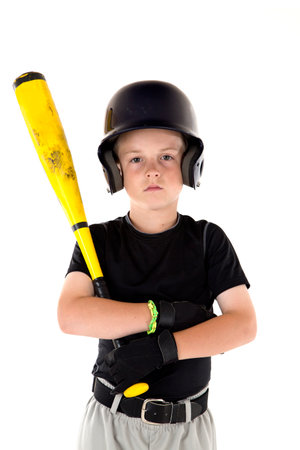 Small boy holding his baseball bat serious