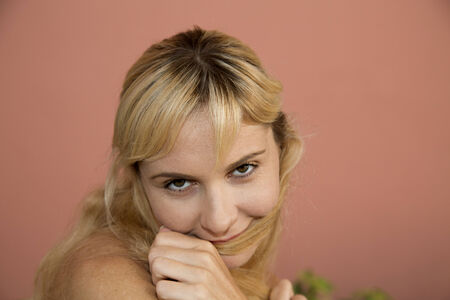 Female model close up playing with hairの写真素材