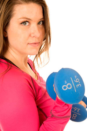 Portrait of female model lifting blue barbellsの写真素材