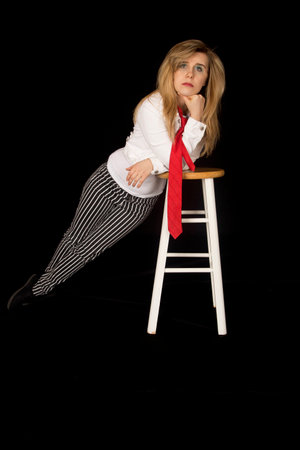 female model leaning on barstool looking forwardの写真素材